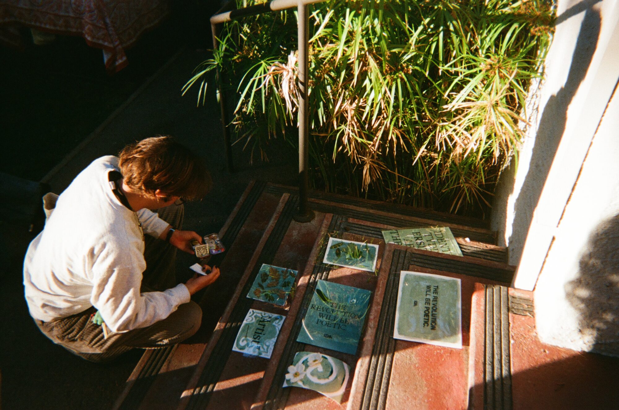 Student at First Friday making cyanotypes.