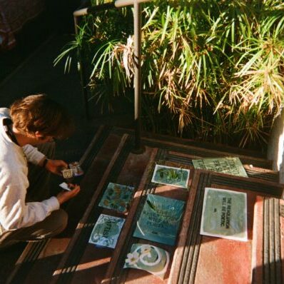Student at First Friday making cyanotypes.